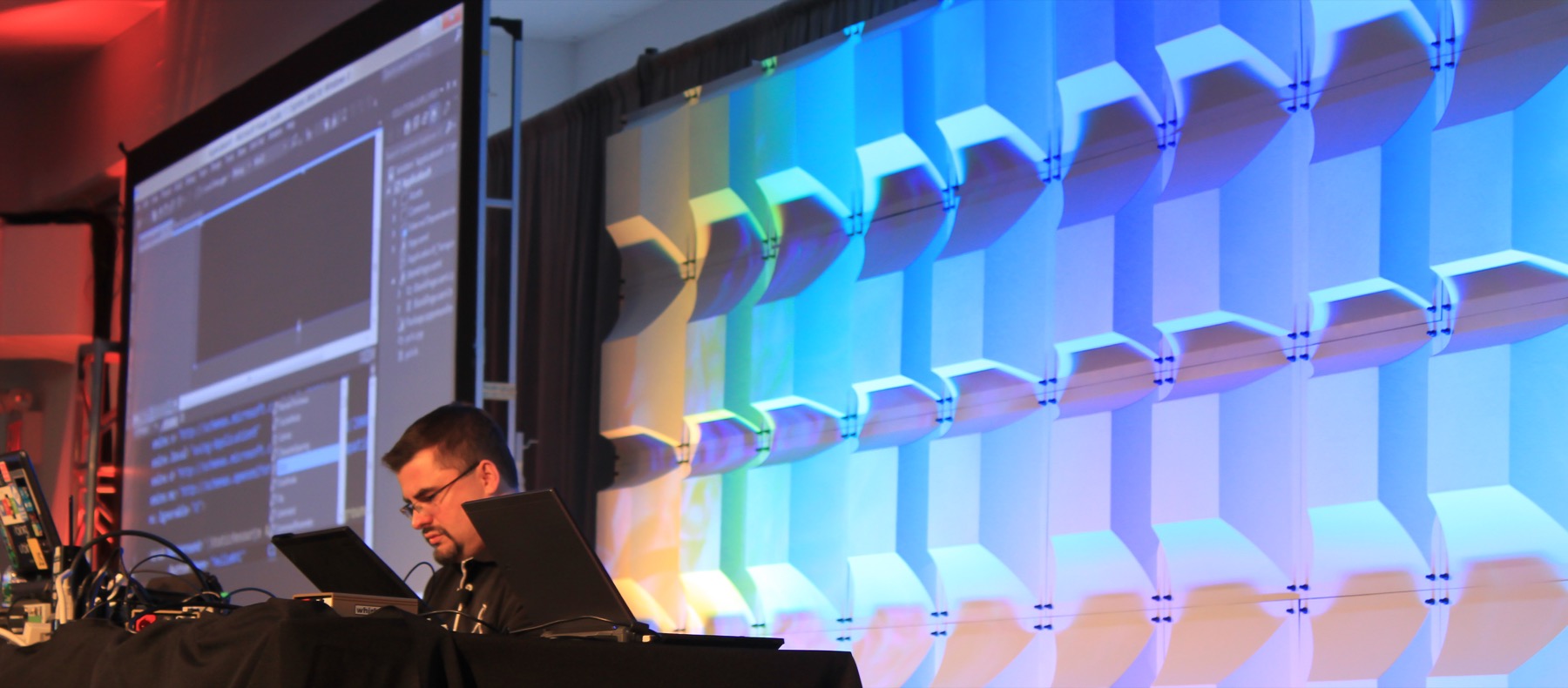 Dave Isbitski coding live onstage with Visual Studio projected behind him at the Windows 8 Developer Bootcamp